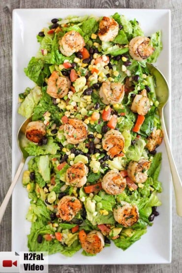 Place the grilled shrimp on the salad with avocado, corn and cilantro dressing on a large platter.