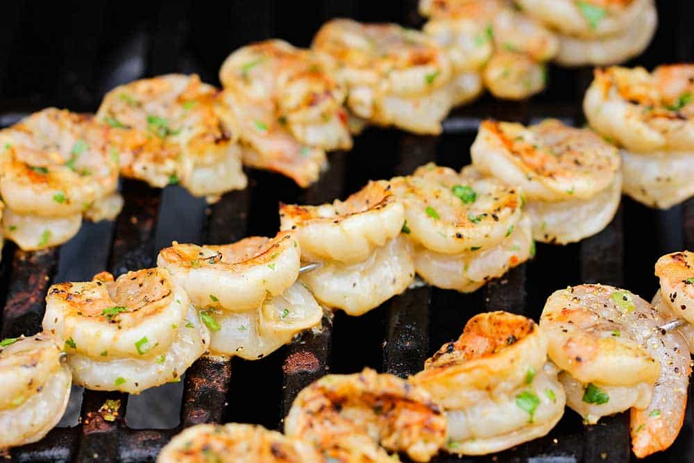 Grill the shrimp using skewers for grilled shrimp salad. 