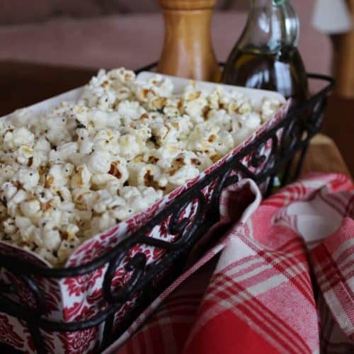 Popcorn with Garlic, Thyme and Black Pepper in a red and white basket next to a red and white patterned napkin