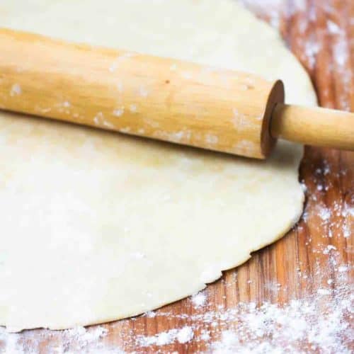 Perfect pie crust on board with rolling pin