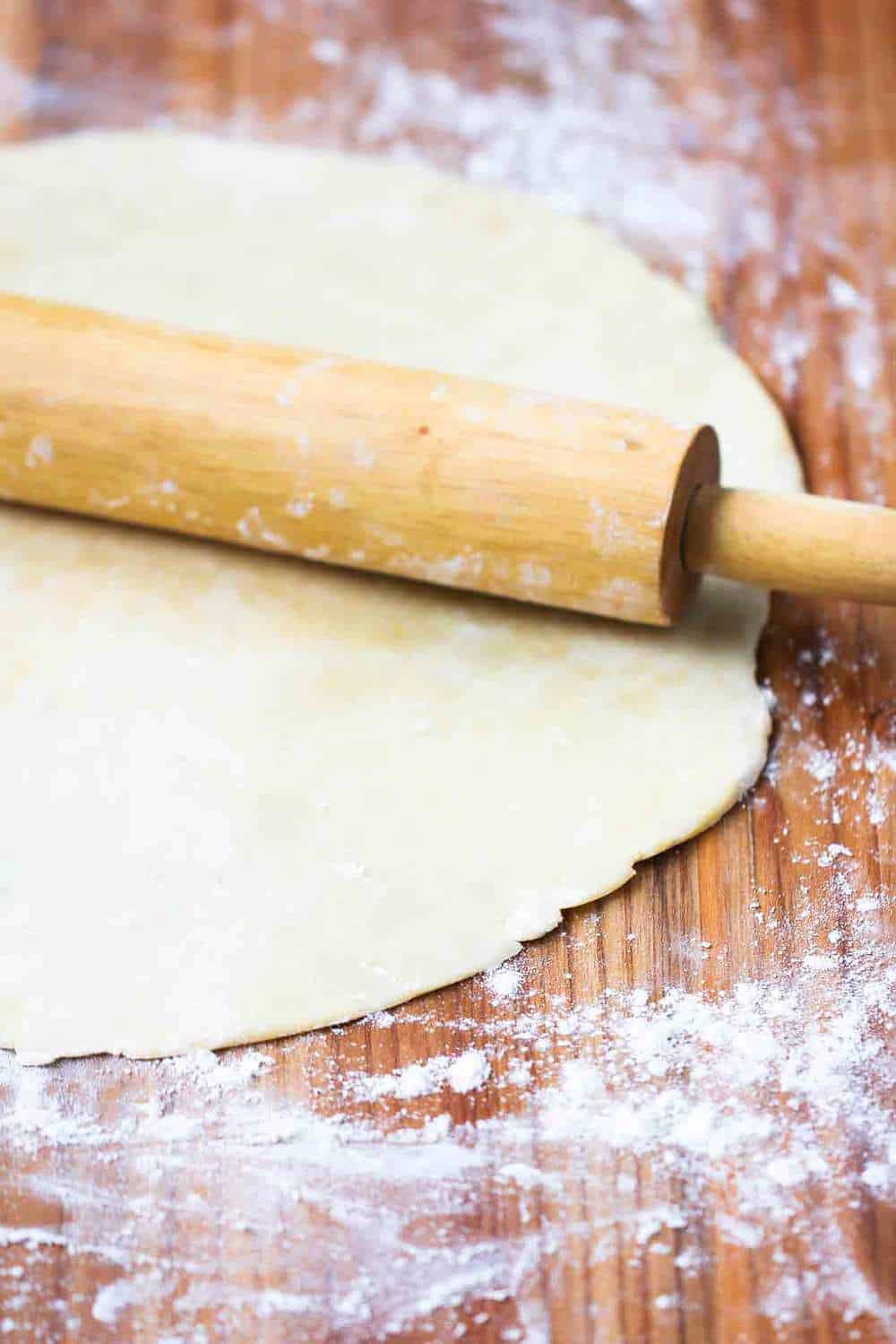 Perfect pie crust on board with rolling pin
