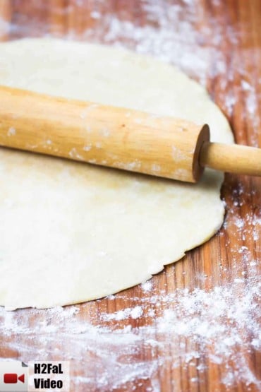 perfect pie crust on a cutting board with rolling pin