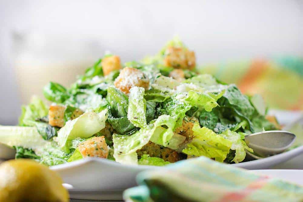 A close up view of a classic Caesar salad on a plate. 