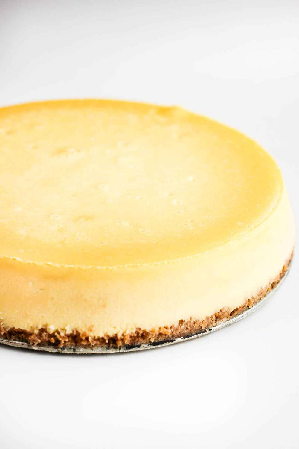 New York Cheese Cake on a tin pie plate.