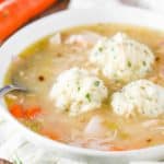 A white bowl of homemade chicken and dumplings.