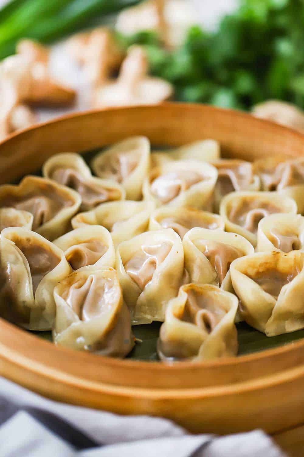 A bamboo steamer filled with freshly steamed vegetarian dumplings. 