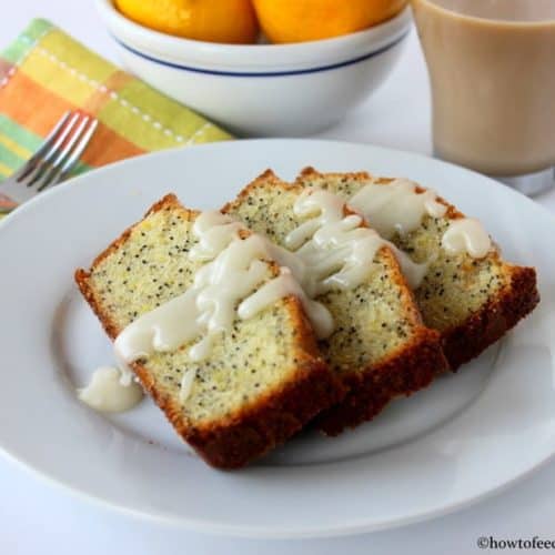 Incredible lemon poppy-seed pound cake on a white plate next to a patterned napkin and fork