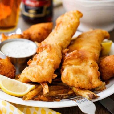 A plate of classic English fish and chips with homemade tartar sauce.