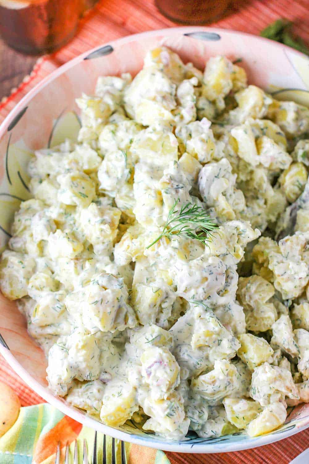 A large pink bowl holding freshly made best-ever potato salad. 