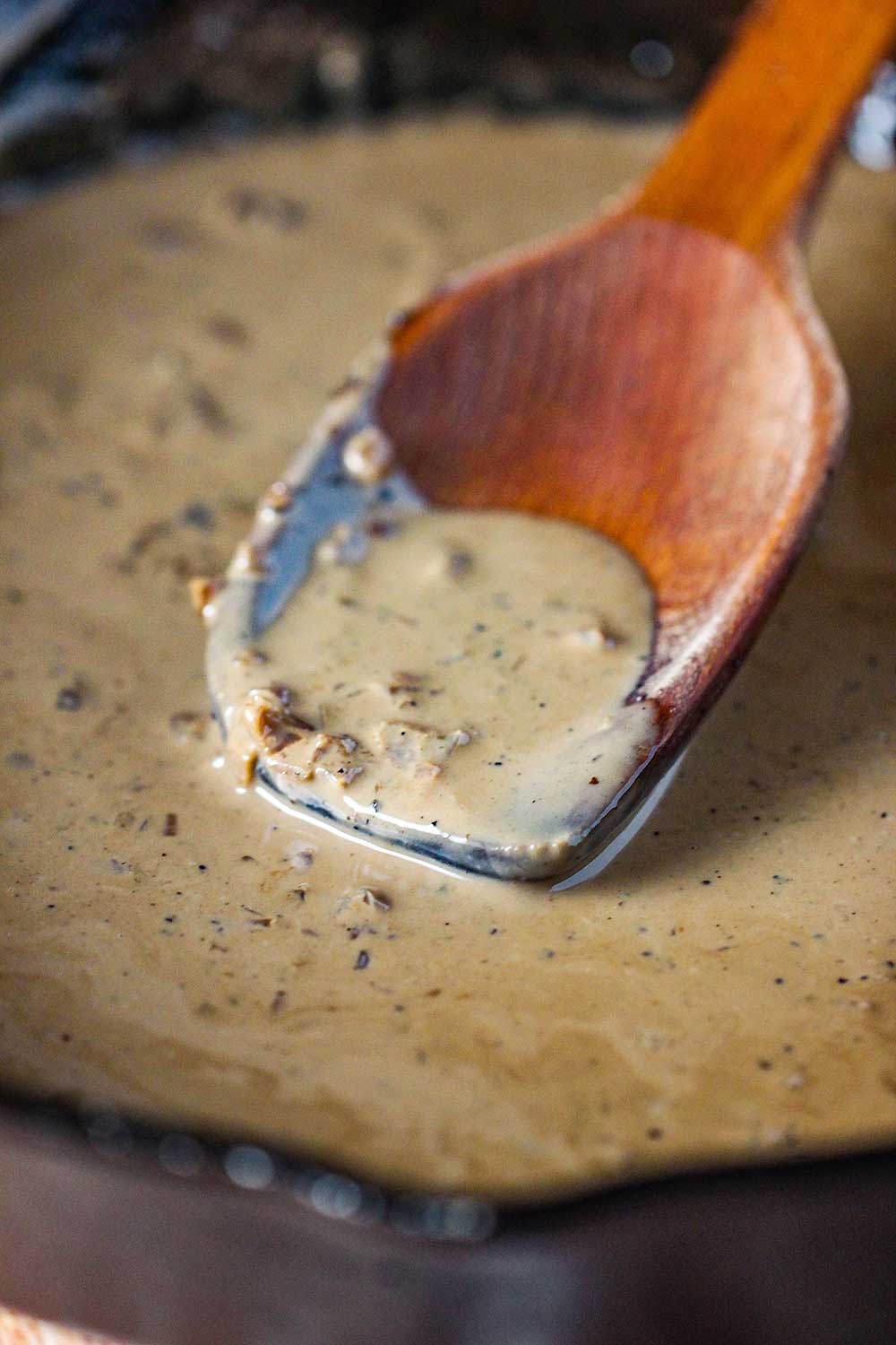 Cook the Steak au Poivre sauce in a large skillet with a wooden spoon. 