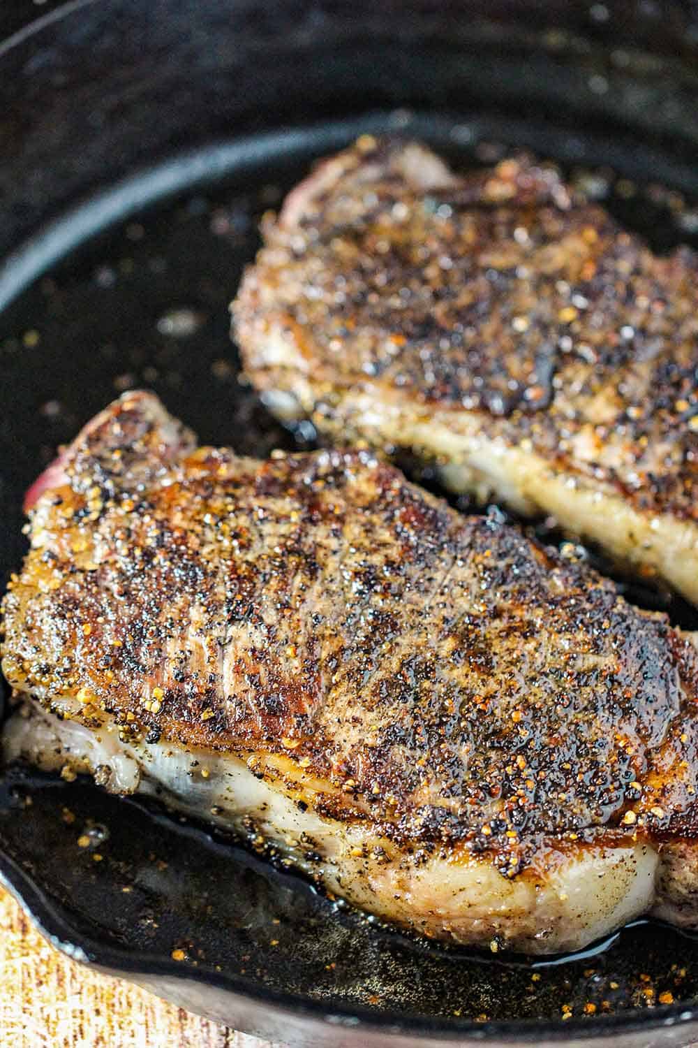 Sear the steaks in a hot cast iron skillet. 