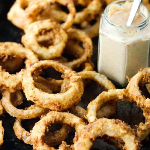 Steak house onion rings on a large baking sheet