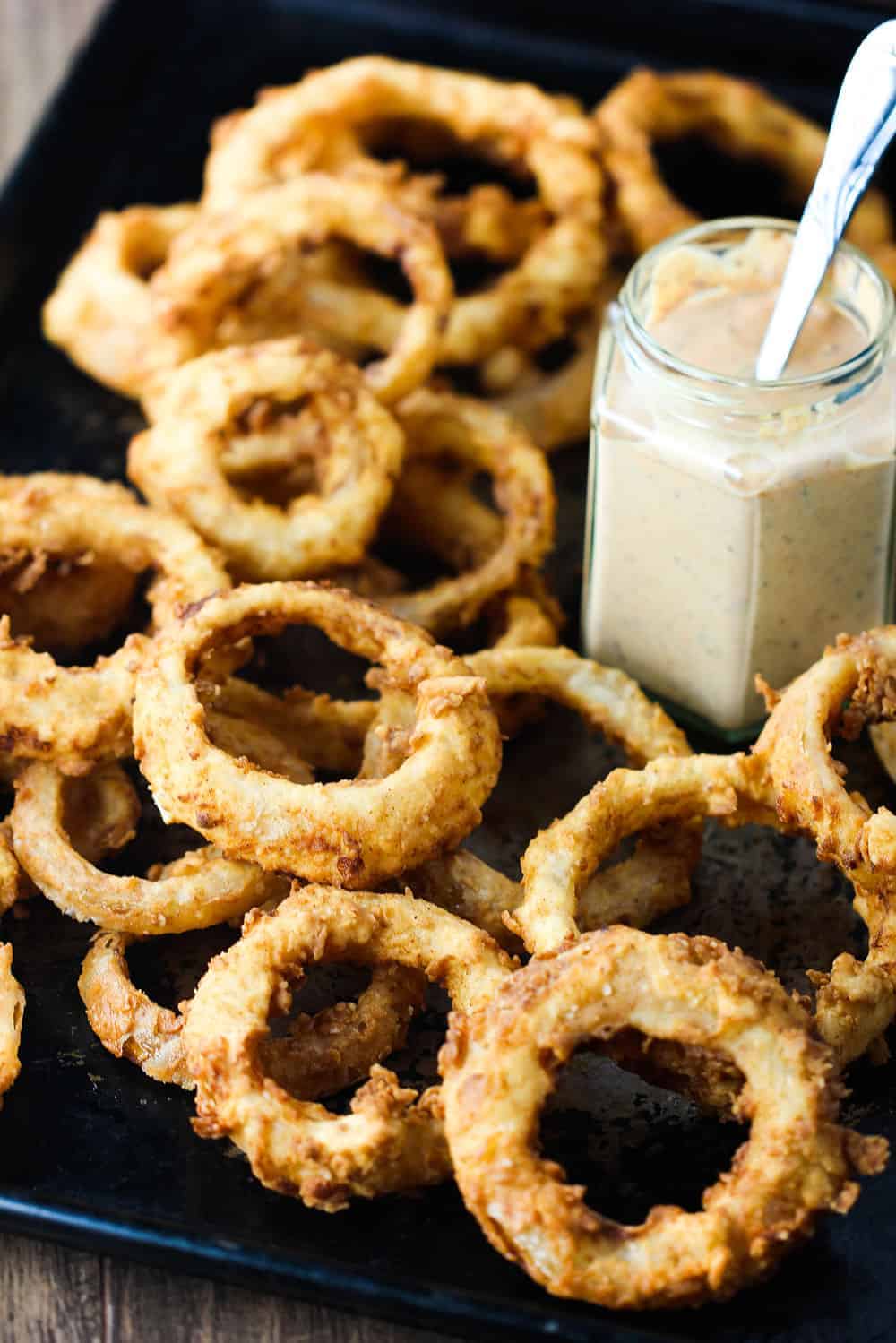 Steak house onion rings on a large baking sheet