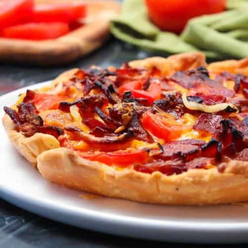 Tomato Cheddar and Bacon Pie on a white plate