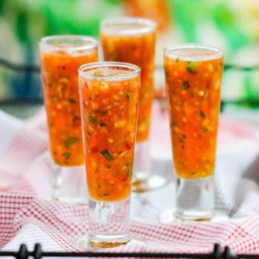 Pour gazpacho into chilled shot glasses for serving.