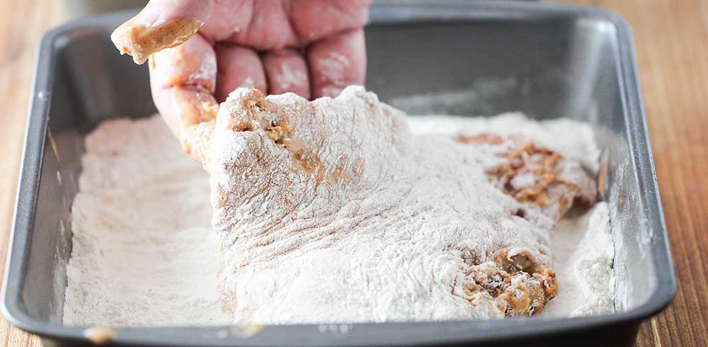 A final dredge through seasoned flour for crunch chicken fried steak. 