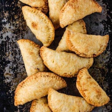 Classic meat pies on a rustic baking sheet