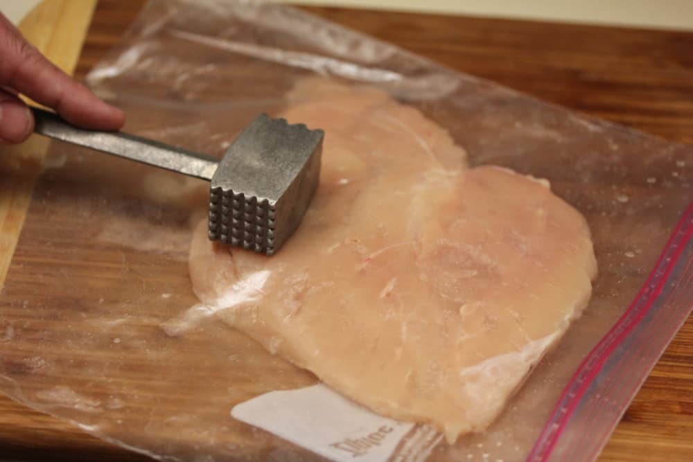 Flatten the chicken breast between sturdy freezer bags