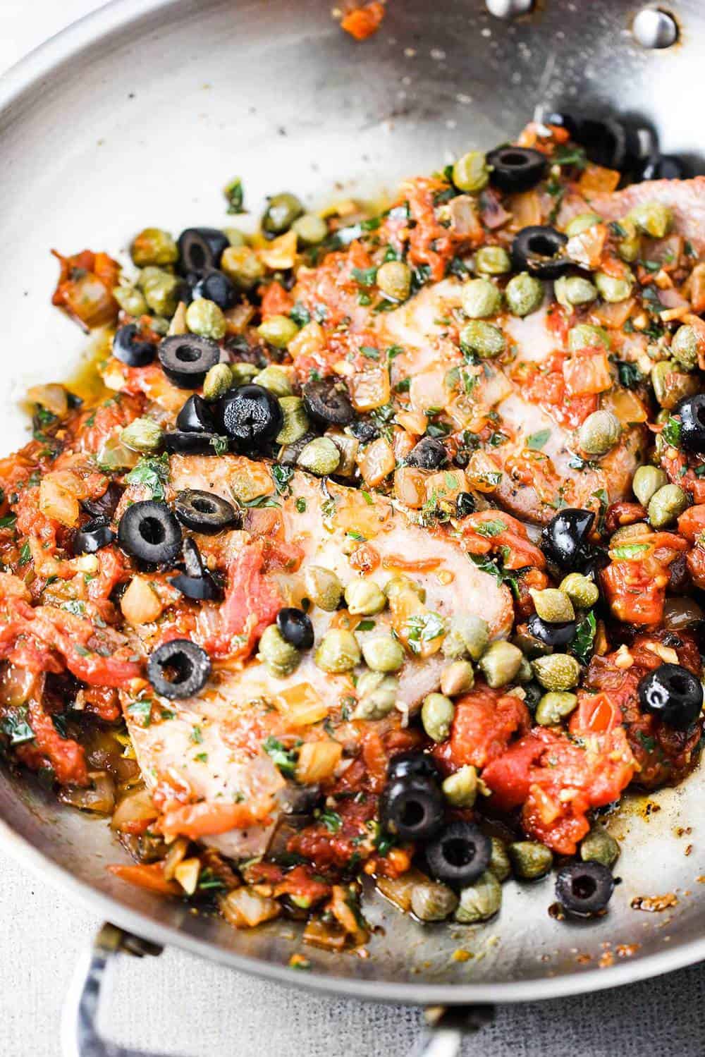 Mediterranean tuna steaks in a metal skillet