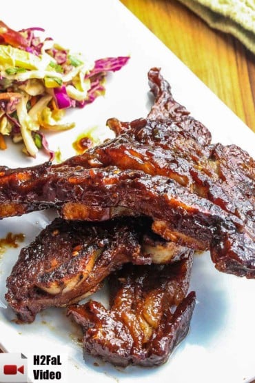 Asian Braised Short Ribs on a white platter with Asian slaw