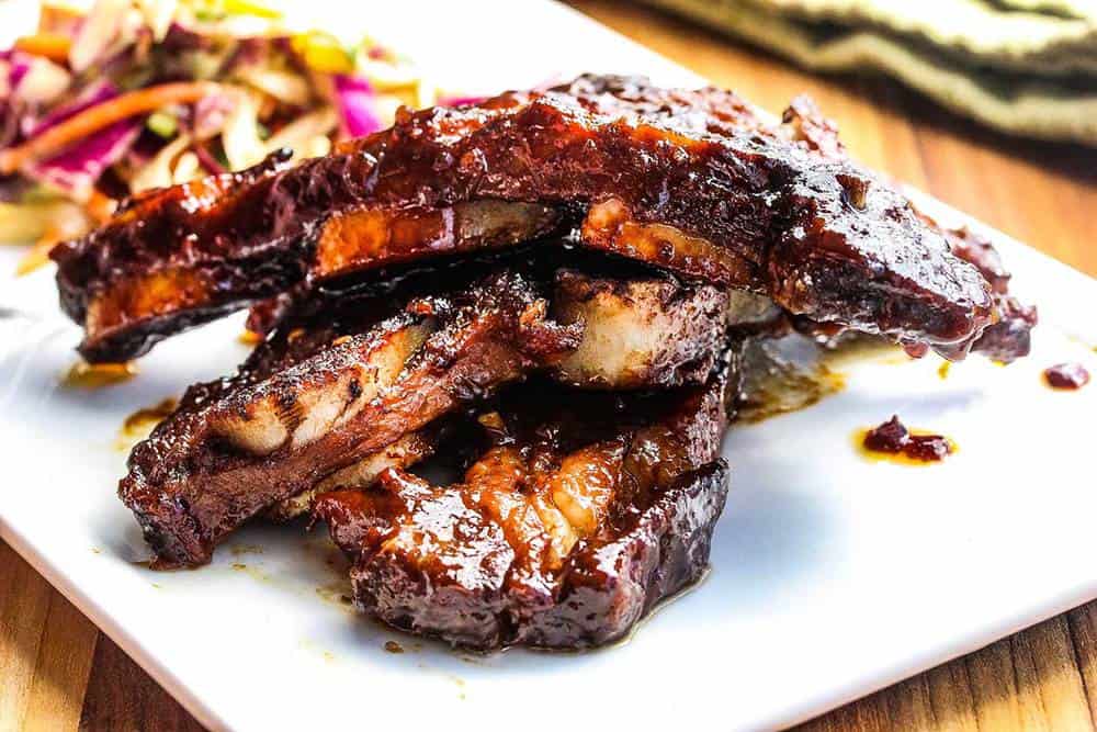 Asian Braised Ribs stacked onto a white platter