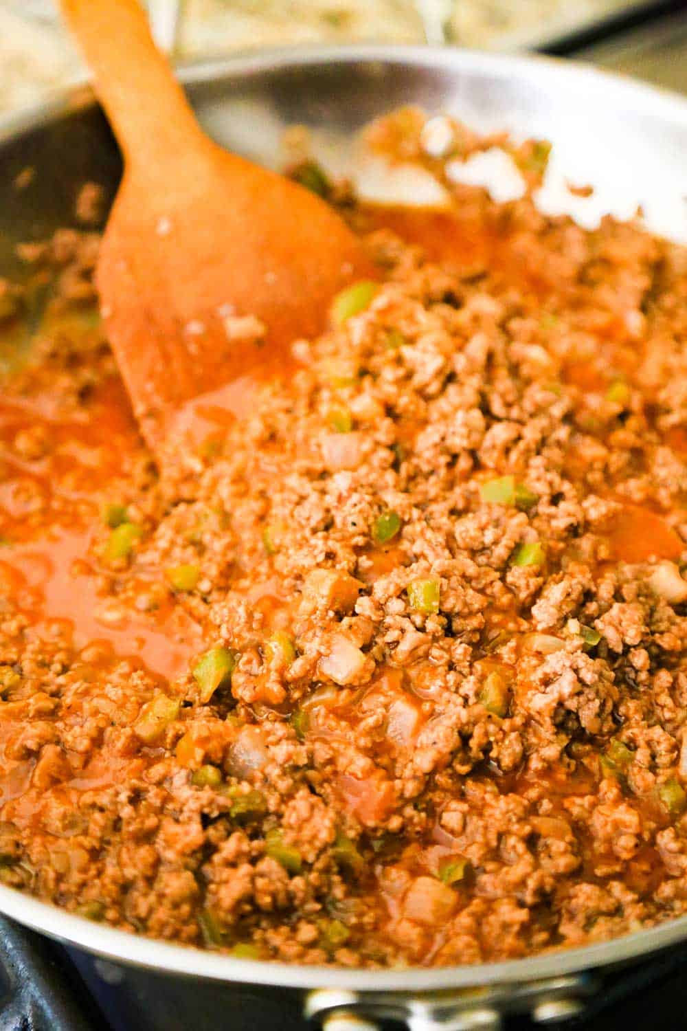 A large silver skillet filled with juicy sloppy joes mixture. 