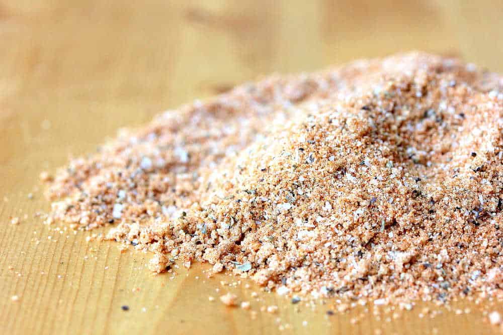 A small pile of a perfect BBQ rub sitting on a wooden cutting board. 