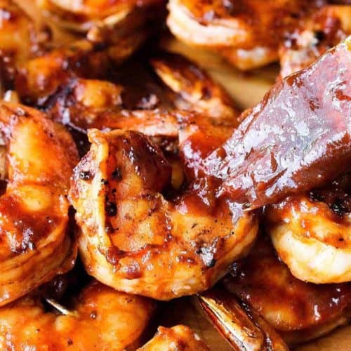 Best ever BBQ shrimp with homemade BBQ sauce being slathered on the shrimp.