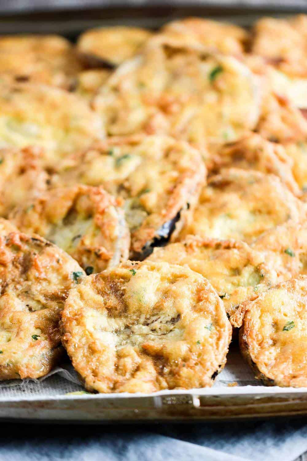 A platter of fried eggplant discs for authentic eggplant parmesan