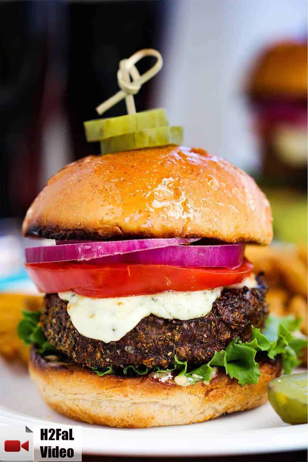 Black and bleu burger on a white plate