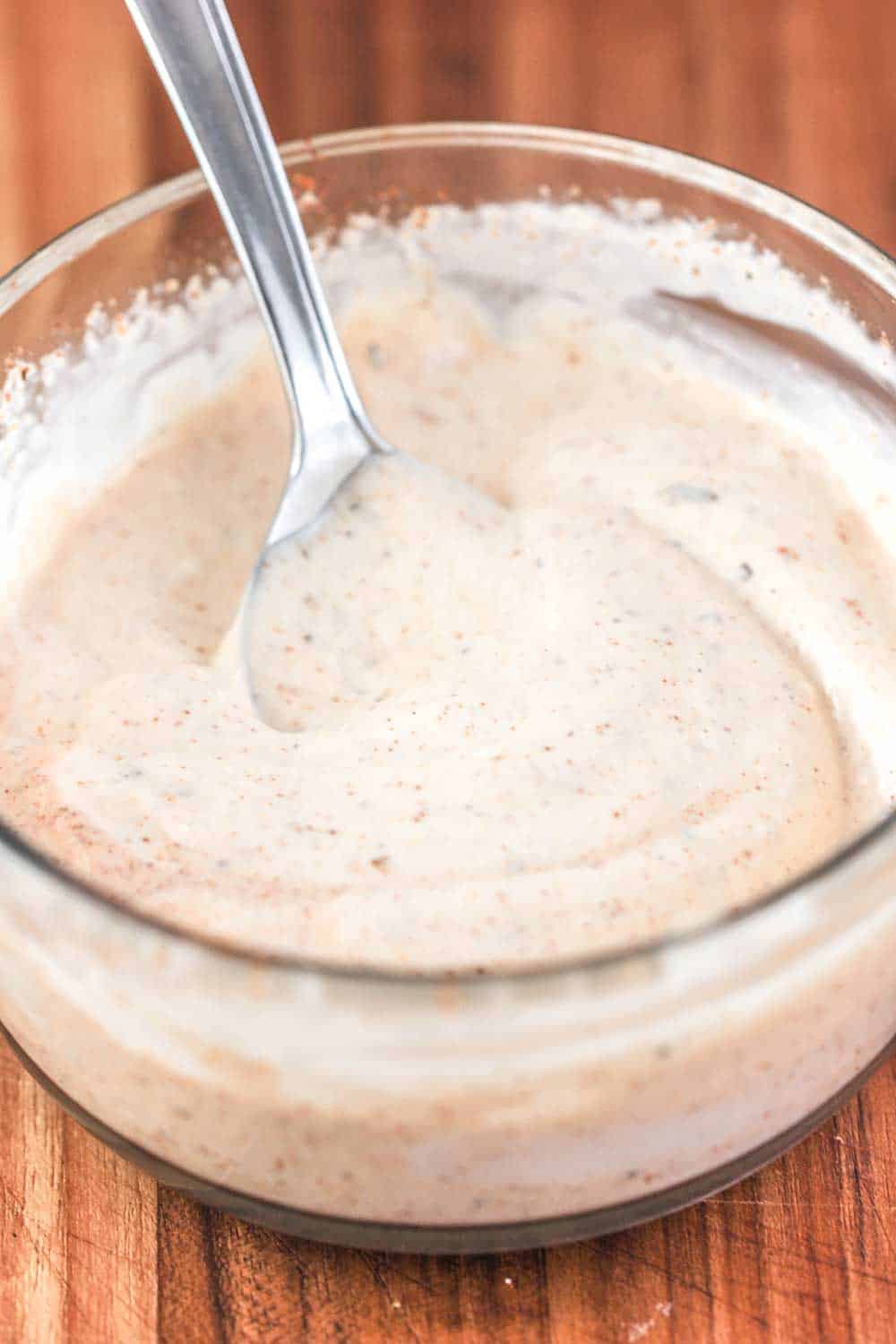 A small glass bowl of cajun mayonnaise. 