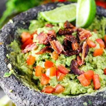 A molcajete filled with homemade fresh guacamole