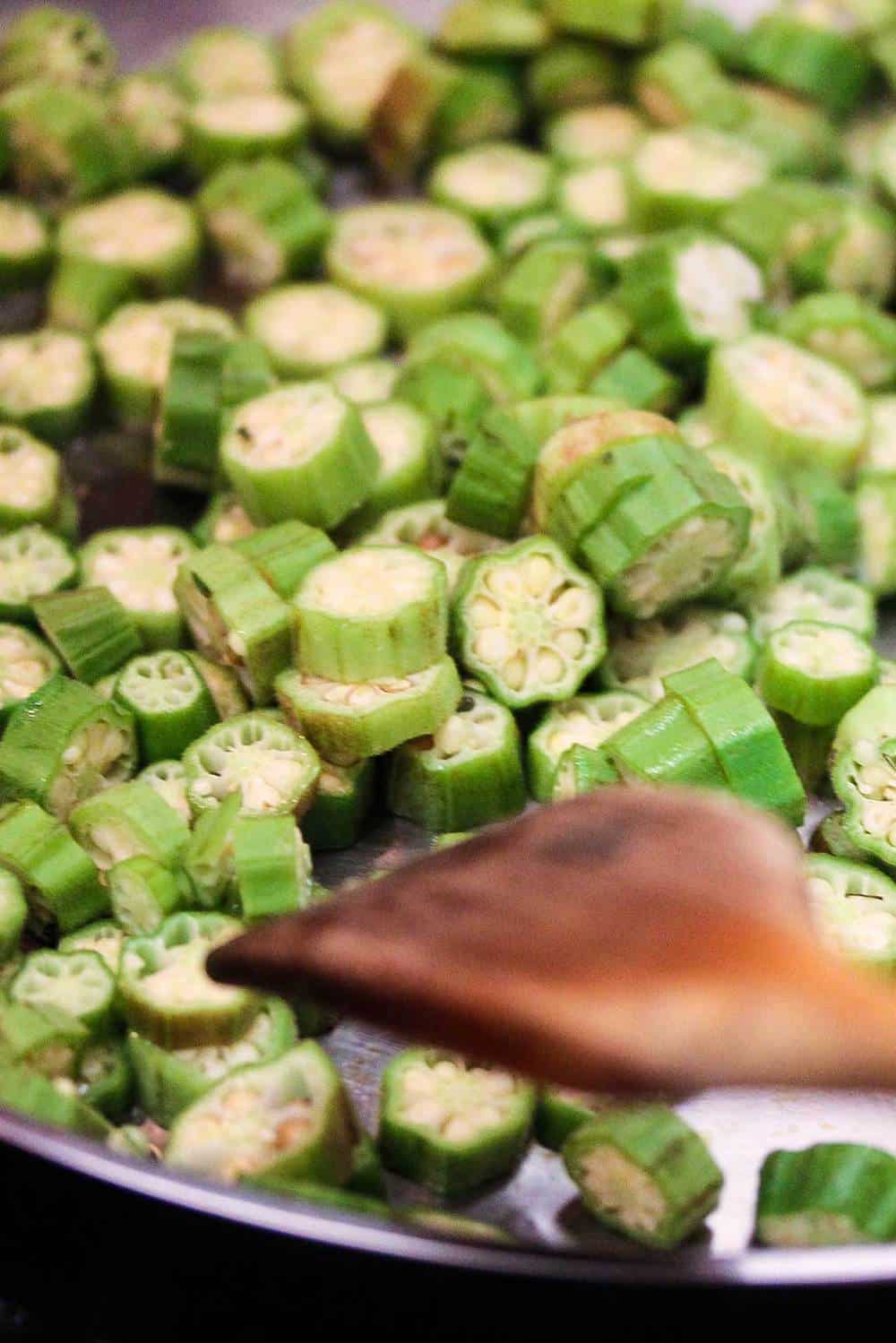 cut okra in a hot skillet and wooden spoon