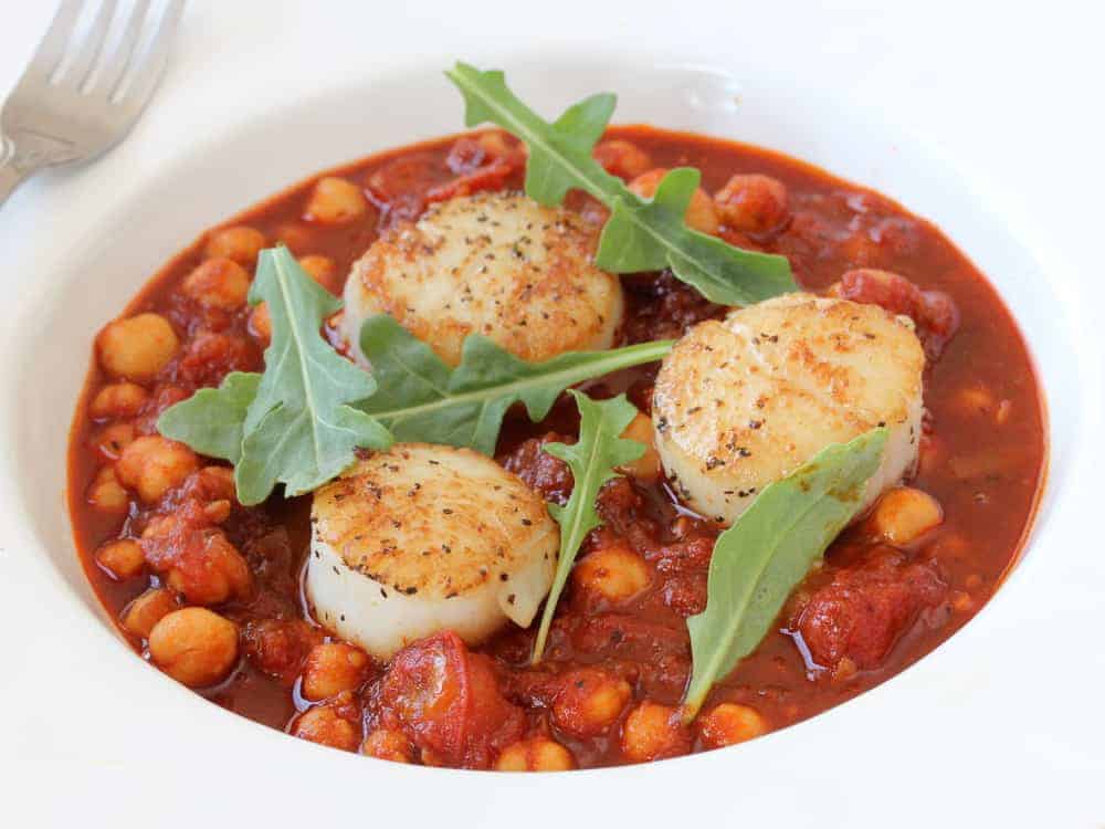 Seared scallops with stewed tomatoes and chickpeas