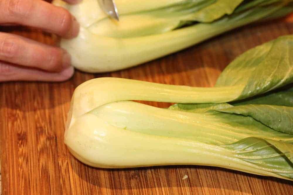 Cut the tough white ends off the baby bok choy