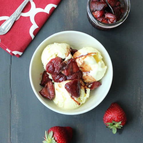 Olive Oil Ice Cream with Roasted Balsamic Strawberries next to a red patterned napkin