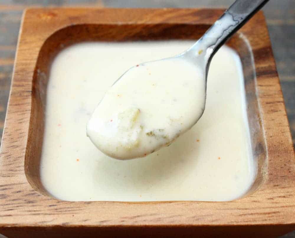 Alabama white sauce in a wooden bowl.