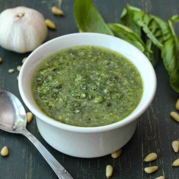 Food processor pesto sauce in a small white bowl.