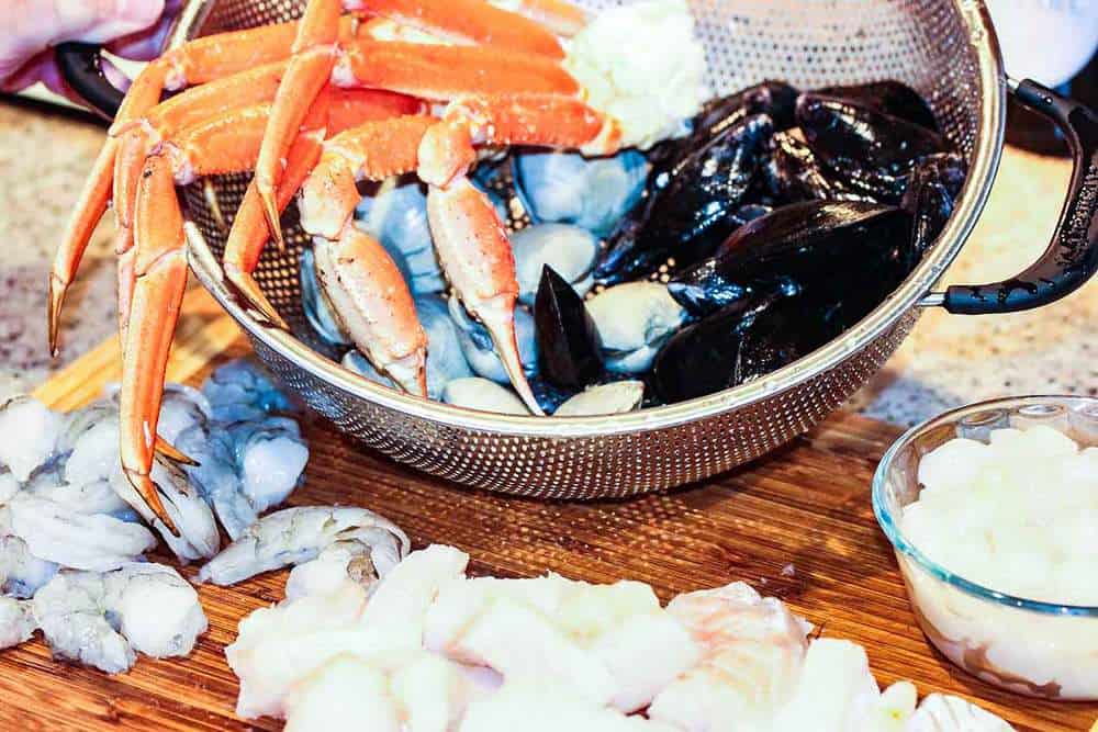 Crab, mussels and other seafood on a cutting board for cioppino