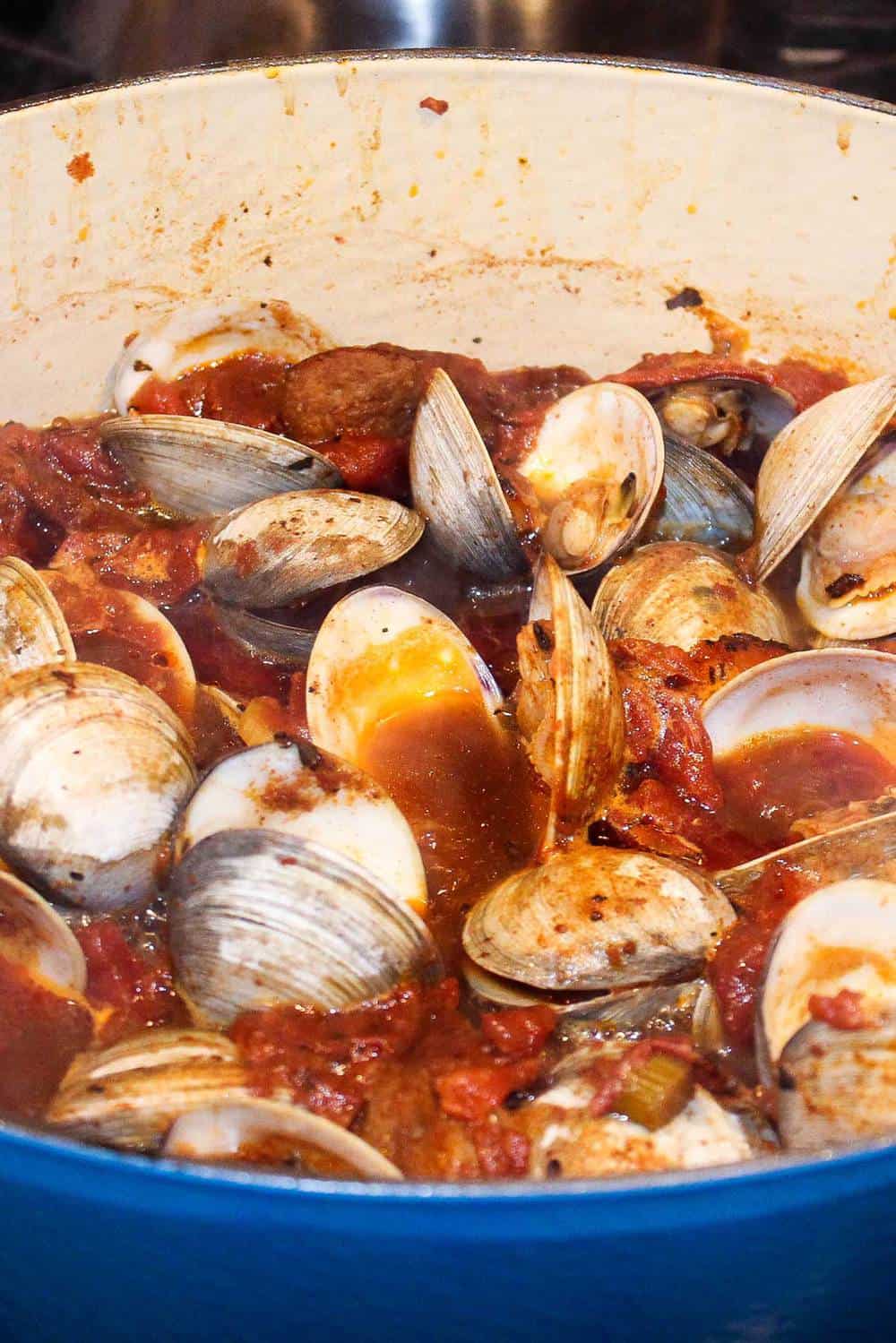 Clams opening in a stew of Portuguese-Style Clam Chowder