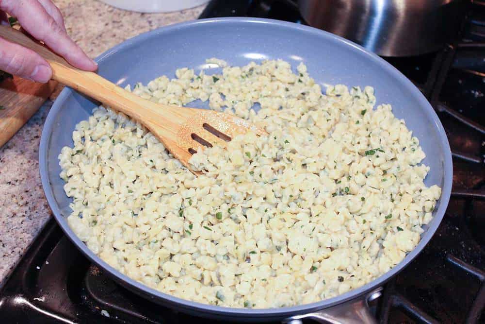 German spaetzle dough being browned in a skillet