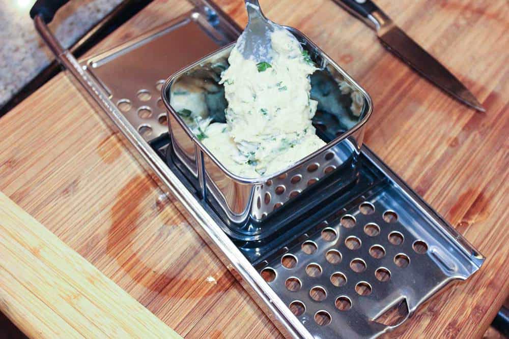 Spaetzle dough being placed into a spaetzle maker