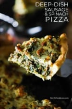 A slice of deep-dish pizza with sausage and spinach being lifted from the pan with a spatula.