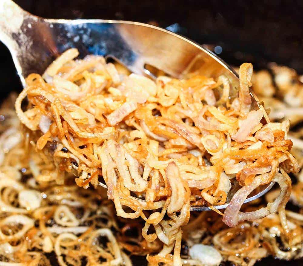 A spoon full of fried shallots for Pho