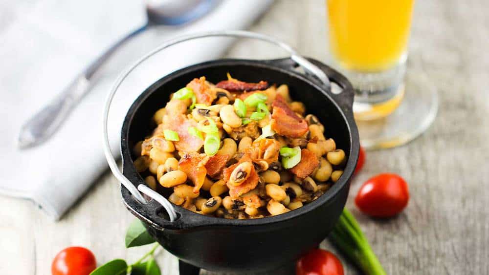 Black-eyed peas with tomatoes in a black crock