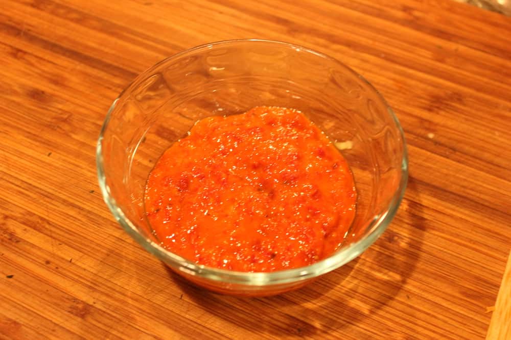 A small glass bowl containing fresh tomato sauce dressing for spiralized ratatouille. 