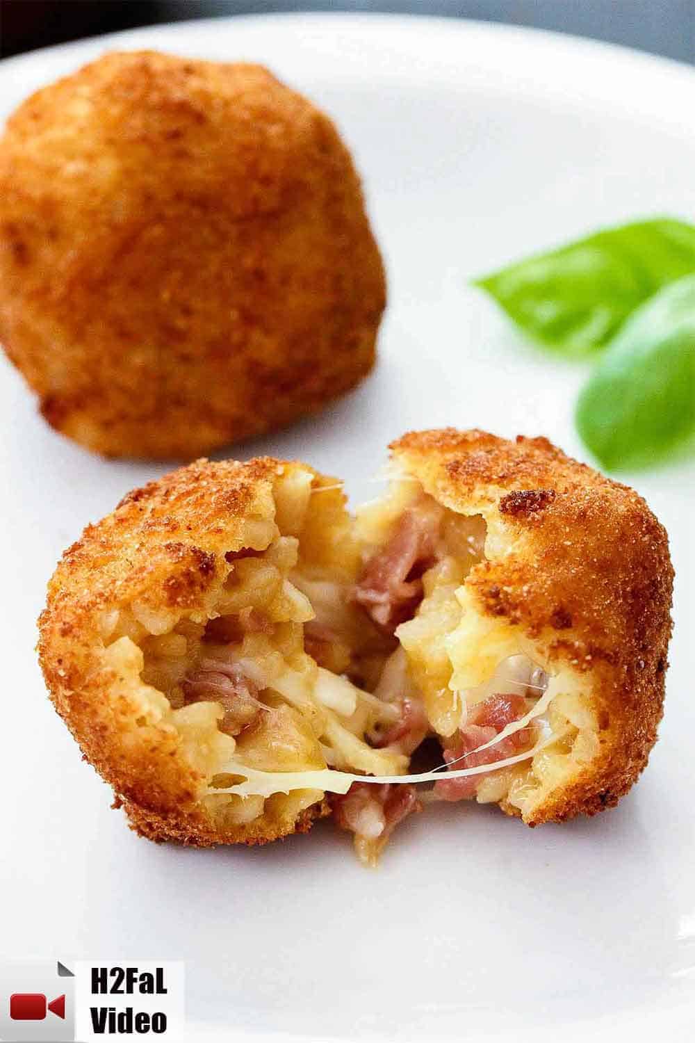 Split the arancini open and see the melted cheese and prosciutto