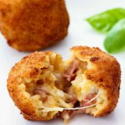 A white platter with Arancini
