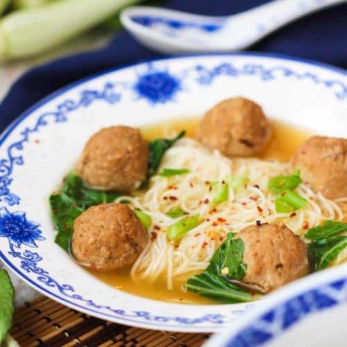 Asian Fusion Wedding Soup in a patterned bowl next to a dark napkin