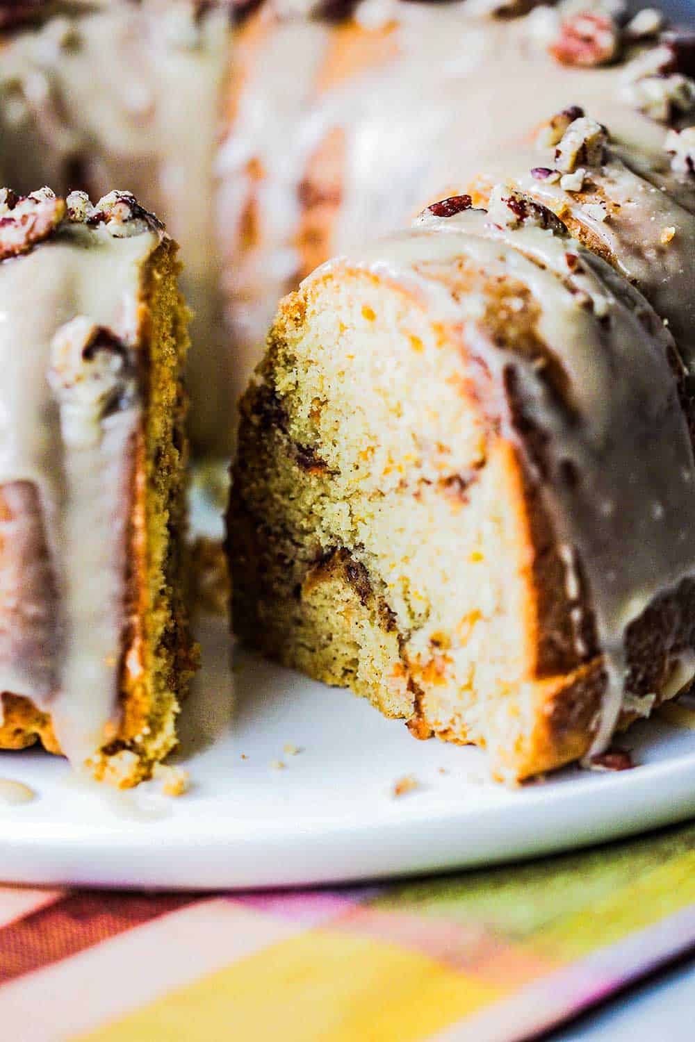 A sweet potato bundt cake with a slice removed from it. 